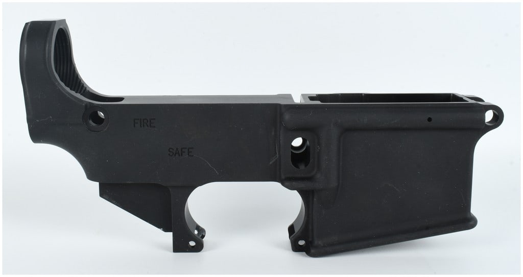 Stripped AR-15 Style Lower Receiver in Matte Black Anodized Aluminum: This component is an AR-15 style stripped lower receiver blank, manufactured from forged aluminum with a matte black anodized finish. The receiver features a milled fire control pocket, drilled pivot 