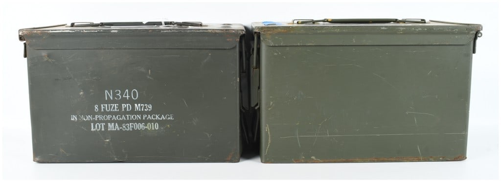 Two U.S. Military M2A1 Ammunition Cans 11x6x8: This lot consists of two U.S. military M2A1 steel ammunition cans, also known as .50 caliber cans, finished in olive drab green paint. Both containers feature a top-loading design with a removable