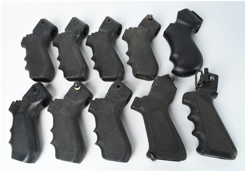 10 Black Polymer Tactical Pistol Grips: A collection of 10 tactical pistol grips constructed from black molded polymer. The assortment features several ergonomic designs, including grips with integrated finger grooves and checkered
