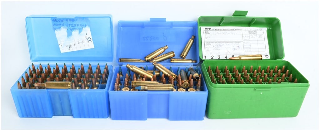 A Lot of 148 Winchester-Western .22-250 Remington Cartridges with 11 Empty Brass Casings: This lot comprises 148 loaded cartridges and 11 empty brass casings, all chambered in .22-250 Remington. The ammunition appears to be handloaded and is organized within three MTM plastic storage boxes
