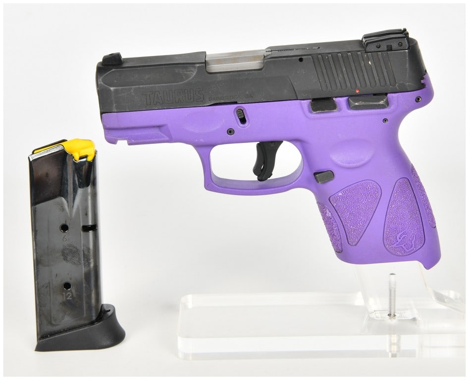 Taurus G2c Semi-Automatic Pistol 9mm with 3.2 Inch Barrel: This is a Taurus G2c semi-automatic pistol chambered in 9mm. It features a 3.2-inch barrel and a black finished carbon steel slide paired with a purple polymer frame. The frame incorporates textured g