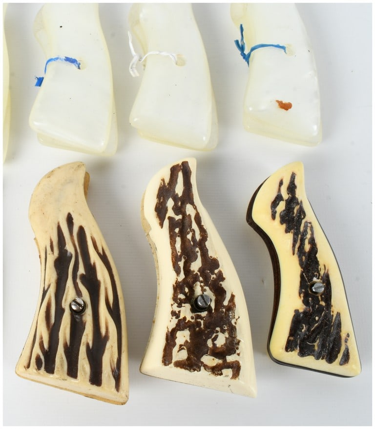 Seven Sets of Assorted Pistol Grips Including Faux Pearl and Stag-Style Examples: This collection features seven sets of pistol grips designed for various handgun frames, primarily revolvers. The assortment includes four pairs of iridescent white grip panels crafted in the style of