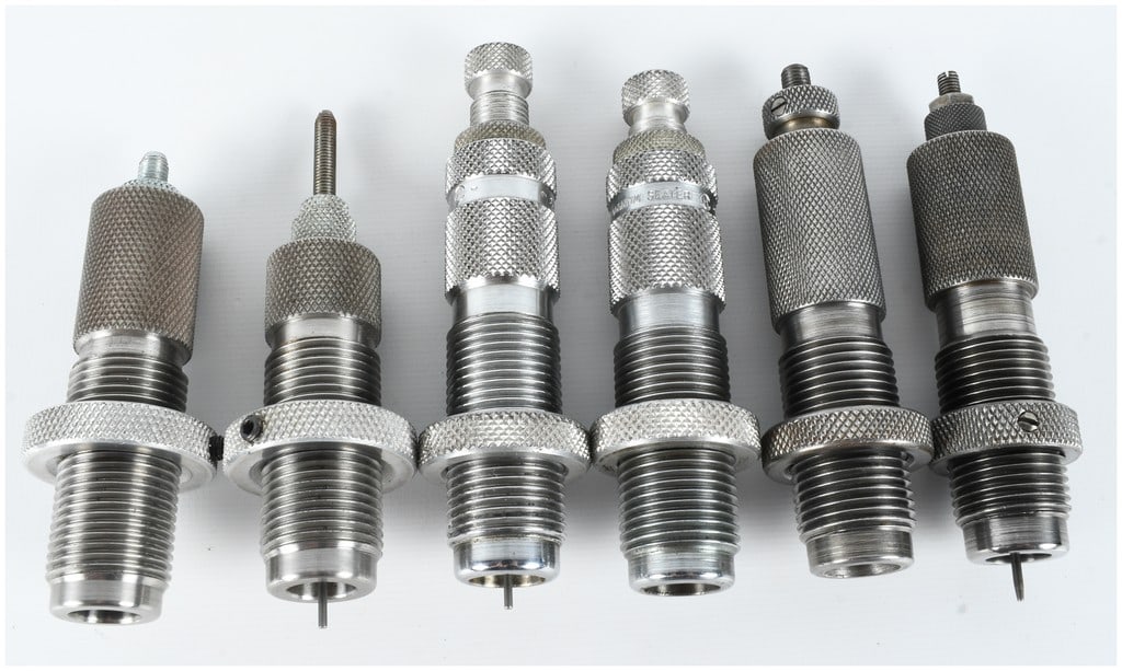 Six Vintage Reloading Dies: A collection of six vintage reloading dies of various calibers and manufacturers, featuring standard 7/8 inch-14 threading. The group includes a steel die marked on the top face RCBS, SEAT, 250 SAV., 