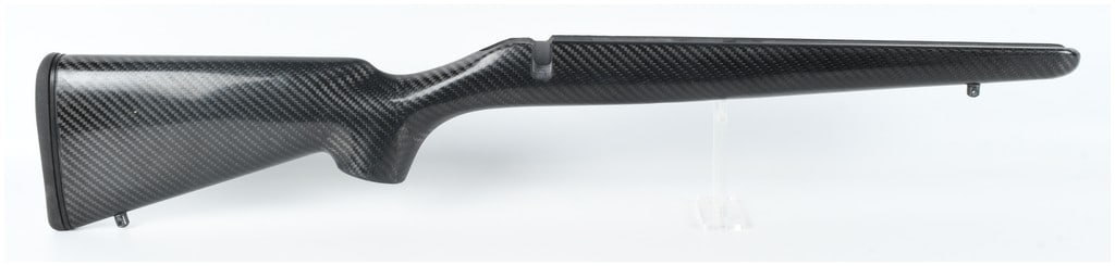 Stocky's Carbon Fiber Rifle Stock Attributed to Howa Mini Action: A right-handed bolt-action rifle stock constructed from carbon fiber composite with a visible 2x2 twill weave pattern and a glossy finish. Based on the profile and inletting, this piece is attributed
