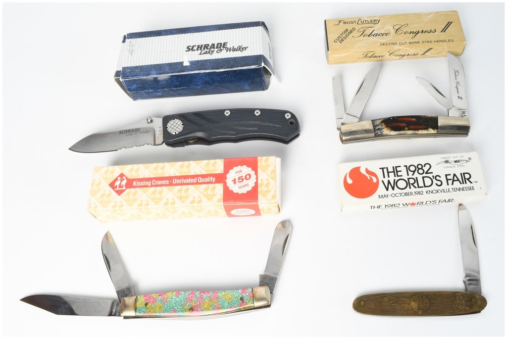 A Collection of Four Pocket Knives Including Schrade Kissing Cranes and Frost Cutlery with Boxes: This collection consists of four distinct pocket knives, each presented with its original factory packaging. The first item is a Schrade Lake and Walker folding liner-lock knife, model SLW2. It featur