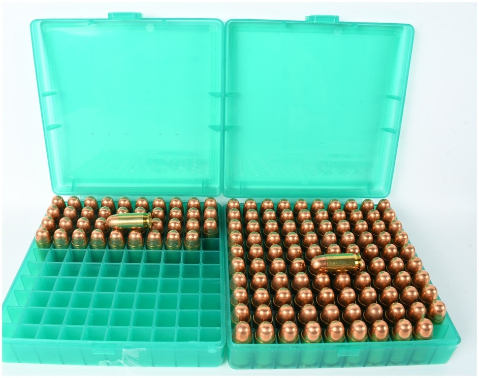 A Lot of 140 Rounds of Handgun Ammunition with Two Cabela's Storage Cases: This lot consists of 140 rounds of handgun ammunition housed in two green translucent plastic Cabela's brand flip-top storage cases. The ammunition is constructed with brass casings and copper-jackete