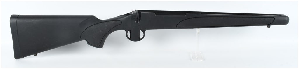 Remington 700 Synthetic Stock with Integrated Trigger Guard: A synthetic bolt-action rifle stock manufactured by Remington for the Model 700 series. The stock is constructed from matte black polymer and features textured gripping panels on the forend and pistol