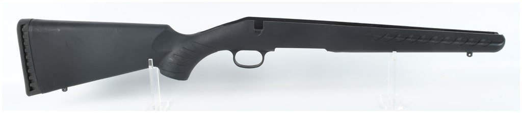 Ruger American Short Action Synthetic Rifle Stock with V-Blocks: A black synthetic rifle stock designed for a Ruger American short action. The stock features an integrated trigger guard and a bedding system utilizing aluminum V-blocks for receiver mounting. The ext