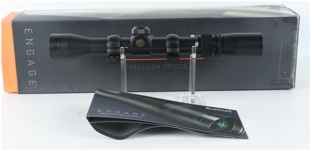 Pine Ridge 2.5-7x32 DML Rifle Scope with Rings and Bushnell Engage Box: A Pine Ridge 2.5-7x32 DML rifle scope featuring a matte black finish. The eyepiece tube is marked 2.5-7X32 DML, MADE IN CHINA, and HX 2007, and the objective bell is marked 2.5-7X32. A medallion on th