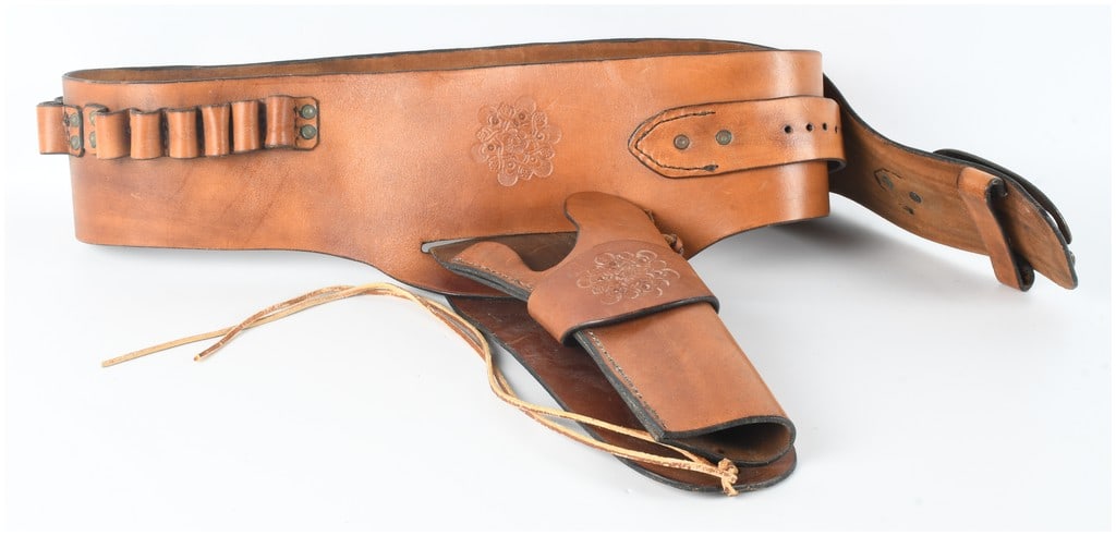 Western-Style Buscadero Leather Belt and Holster Set for .44 Caliber: This lot consists of a Western-style Buscadero drop-loop leather belt and holster set configured for a .44 caliber revolver. The set is constructed from medium-brown leather and features matched stamp