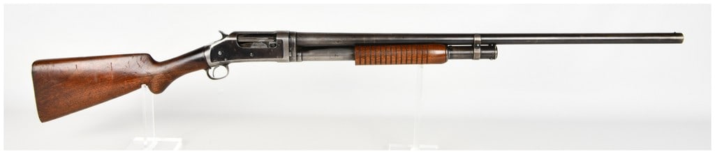 Winchester Model 1897 Pump Action Shotgun 12 Gauge with 30 Inch Barrel: This is a Winchester Model 1897 take-down pump-action shotgun chambered for 12 gauge. It is configured with a 30 inch barrel featuring a full choke and a simple brass bead front sight. The receiver fe