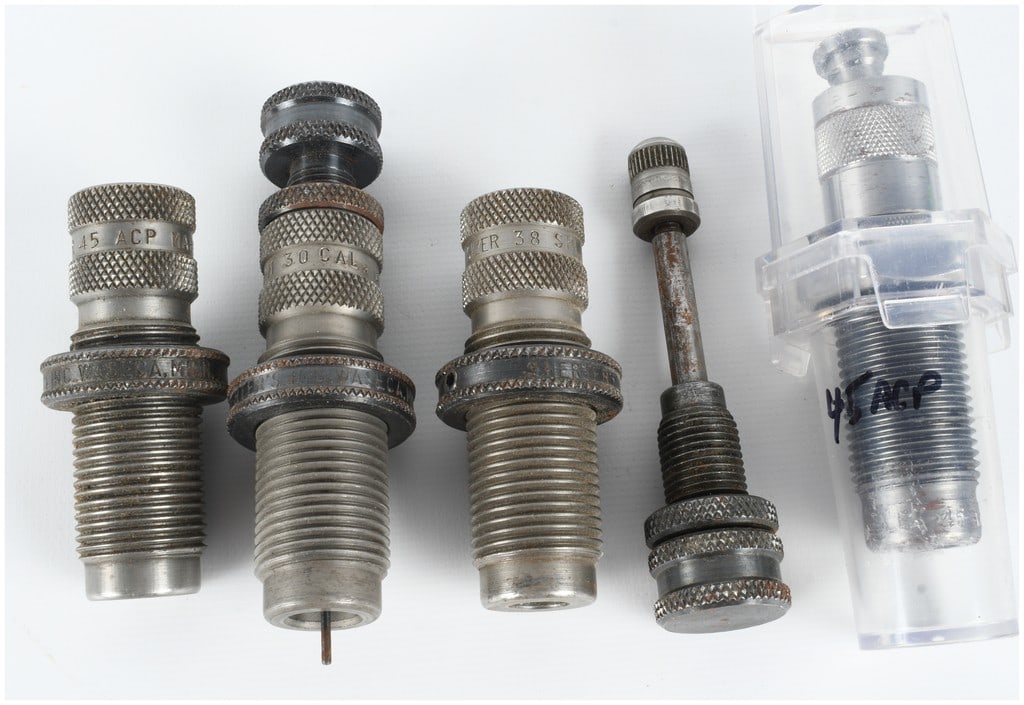 A Collection of Five Herter's and Assorted Reloading Dies and Components: This lot consists of five reloading tool components, including four individual reloading dies and one decapping rod assembly. From left to right, the first item is a steel reloading die with a knurled