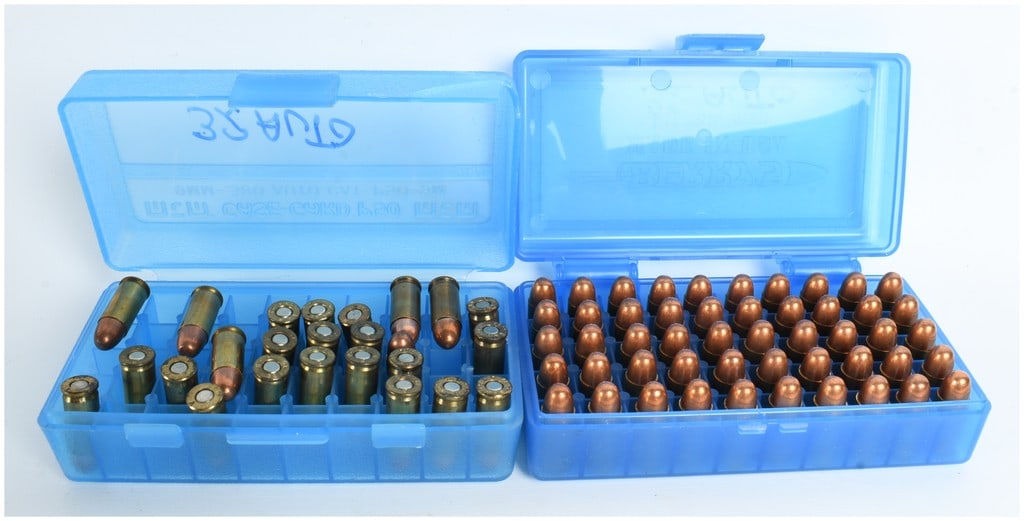 A Lot of 75 Rounds of Mixed .32 Auto Ammunition: This lot consists of 75 rounds of .32 Auto (7.65mm Browning) centerfire ammunition featuring brass casings and copper-jacketed round nose (RN) bullets. The ammunition is housed in two blue translucent