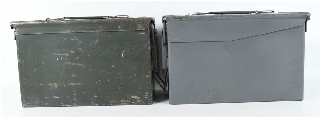 Two US Military Style Metal Ammunition Cans with S.C.F. Markings: This lot consists of two metal ammunition storage cans, consistent in design with US military small arms ammunition boxes such as the M2 series. One container is finished in traditional olive drab gre