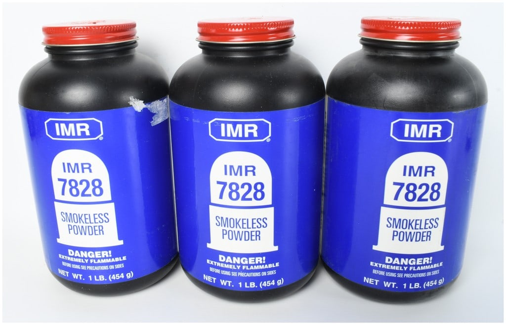 Three 1 lb. Bottles of IMR 7828 Smokeless Powder: This lot consists of three canisters of IMR 7828 smokeless powder, totaling 3 lbs of powder. Each individual unit is housed in a black plastic bottle with a red ribbed screw-top lid. The containers fe