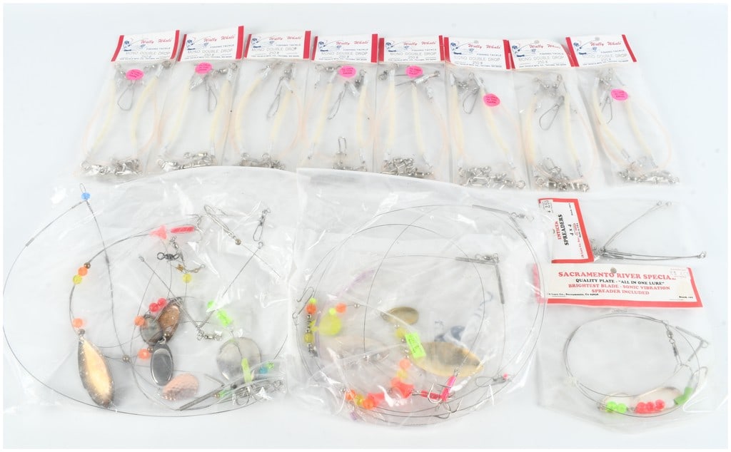 A Collection of Twelve Vintage Saltwater Fishing Rigs and Tackle: A collection of twelve vintage saltwater fishing rigs and tackle, primarily from West Coast manufacturers and presented in their original retail packaging. The group includes multiple Wally Whale bran