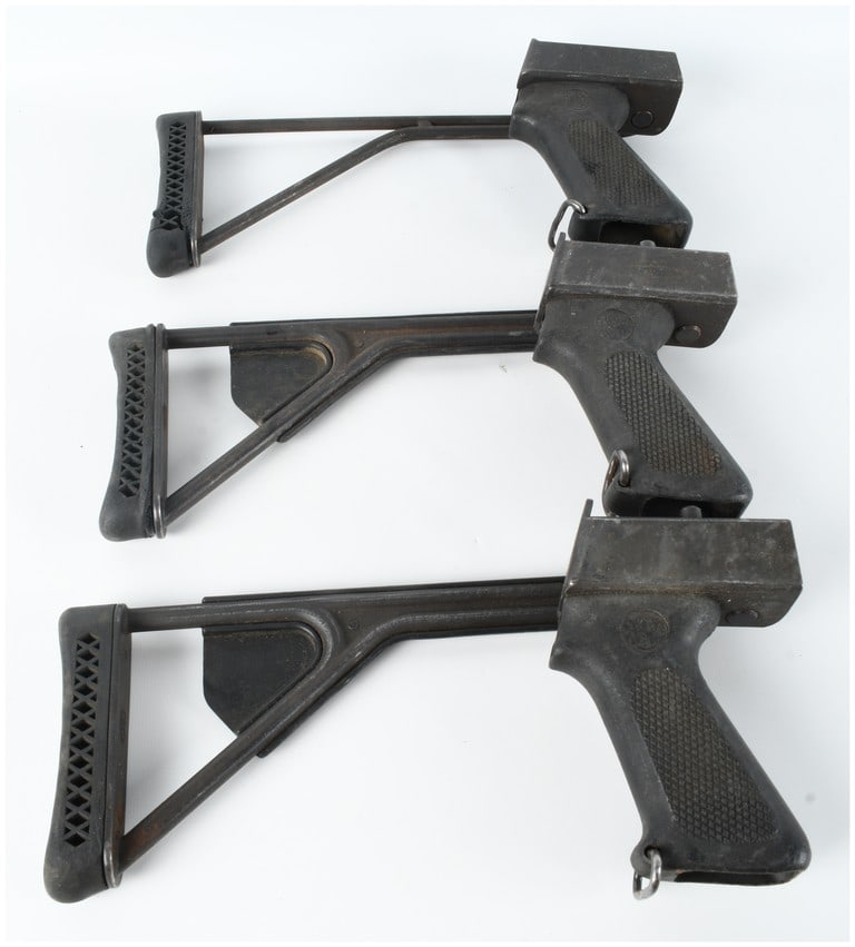 Three Choate Machine and Tool Side Folding Stock Assemblies with Integrated Pistol Grips: This lot consists of three side-folding stock assemblies manufactured by Choate Machine and Tool, each featuring an integrated pistol grip. The collection includes one wire-frame style stock and two r