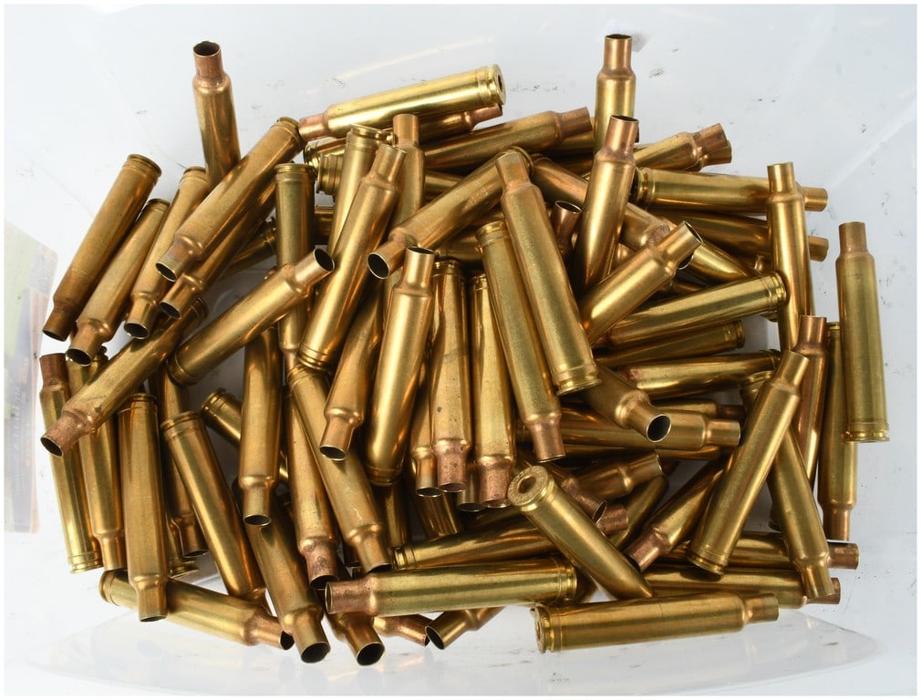 A Collection of 100 .300 Weatherby Magnum Cleaned Brass Casings: This lot consists of 100 once-fired brass rifle ammunition shell casings for the .300 Weatherby Magnum caliber. The casings feature a bottlenecked profile with a distinctive belted base. Detailed insp