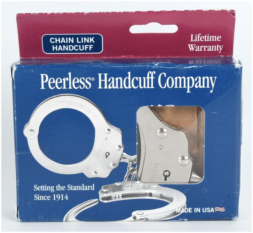 A Pair of Peerless Handcuff Company Model 700C Chain Link Handcuffs in Original Box: This set of professional-grade chain link handcuffs is manufactured by the Peerless Handcuff Company of West Springfield, Massachusetts. The restraints are constructed from nickel-plated steel and fea