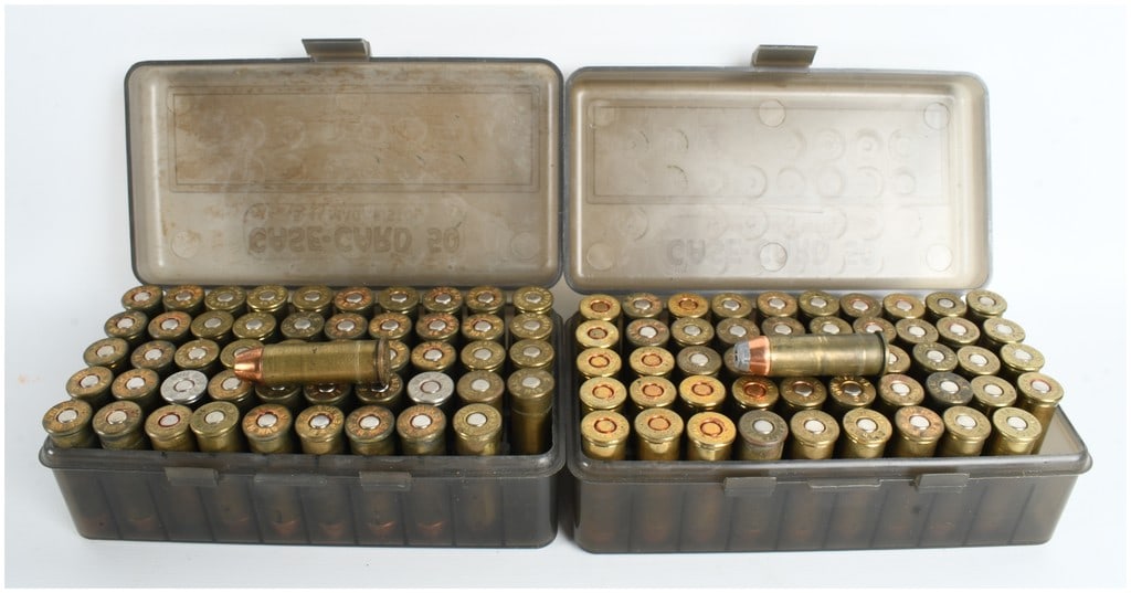 A Lot of 100 Rounds of .44 Remington Magnum Ammunition: This lot consists of 100 rounds of .44 Remington Magnum ammunition organized in two smoke-colored translucent plastic flip-top storage boxes. The ammunition features a mix of bullet profiles including