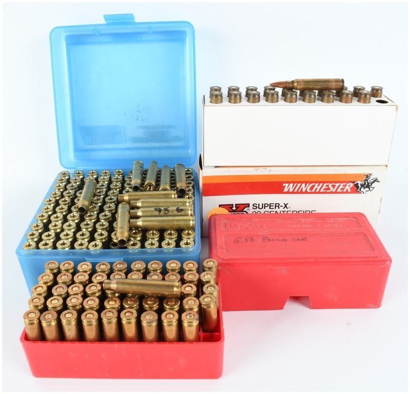 A Lot of 10 Rifle Cartridges and 160 Empty Primed 5.56 Casings: This lot consists of 10 rifle cartridges and 160 empty primed 5.56 casings presented in four assorted containers. Included is a white Winchester Super-X 20-round box containing spent brass cases with 