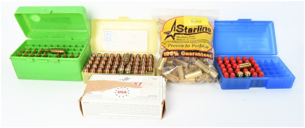 A Lot of 155 Rounds of Mixed Ammunition and 100 New Unprimed .45 Colt Brass Casings: This lot consists of a varied collection of 155 rounds of live ammunition and 100 new, unprimed brass reloading components. The ammunition is organized across several containers and includes 24 rounds
