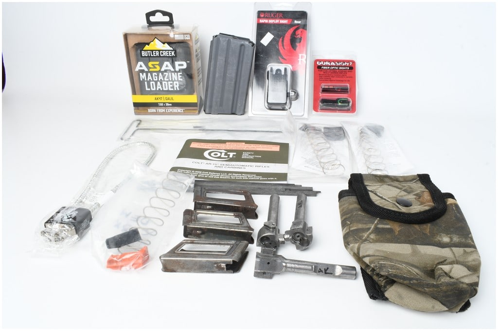 A Collection of 14 Firearm Accessories and Parts Including Sights, Magazines, and ASAP Loader: This assortment consists of 14 firearm accessories and surplus components from various manufacturers. Included in their original retail packaging are a Butler Creek ASAP magazine loader for AK47/Galil