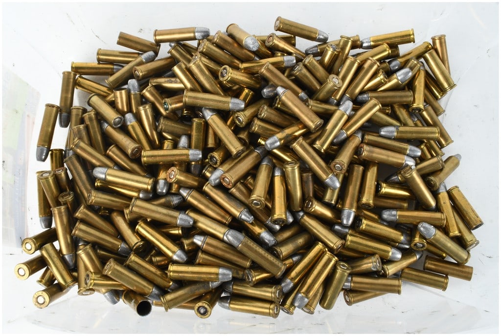 A Lot of 220 .32 Caliber Revolver Cartridges Including .32 H&R Magnum and .32 S&W Long: This lot consists of 220 loose revolver cartridges primarily chambered in .32 caliber, stored within a clear plastic container. The collection features a variety of loads including .32 S&W Long and .3