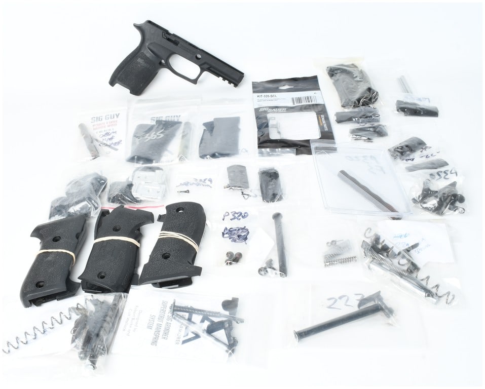 A Lot of Approximately 28 Sig Sauer Handgun Parts and Accessories for P220, P226, P227, P229, P320,: This lot consists of a collection of approximately 28 Sig Sauer handgun parts and accessories designed for various platforms including the P220, P226, P227, P229, P320, and P365 models. The primary co