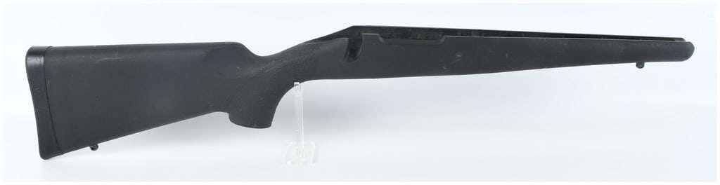 Remington 700 Short Action (S/A) Synthetic Rifle Stock: A black synthetic one-piece rifle stock designed for a Remington 700 short-action (S/A) bolt-action receiver. The construction features a textured pistol grip and forend for improved handling. The but