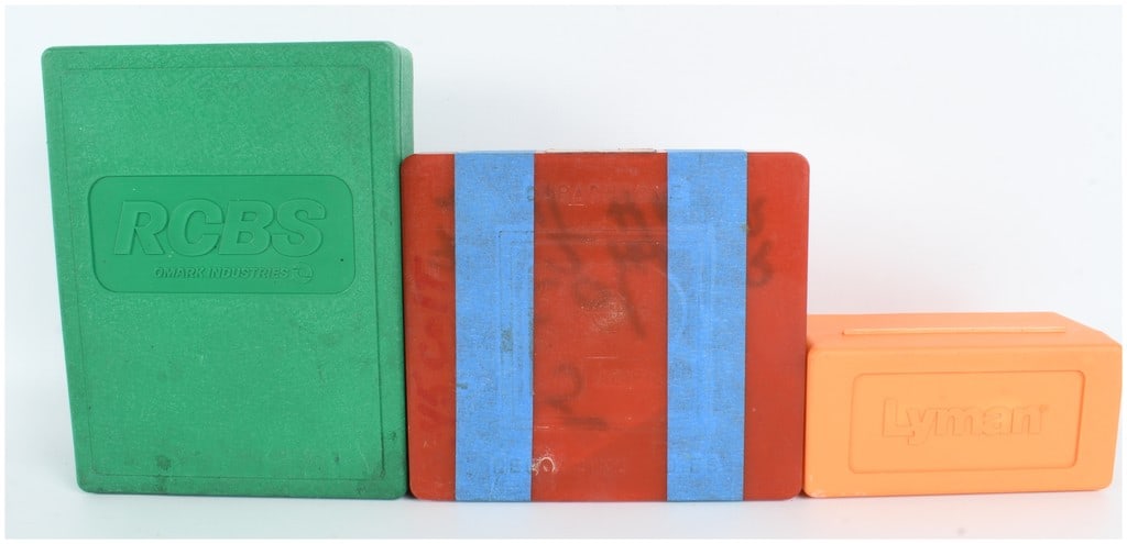Three Reloading Die Sets for .45 Colt and .45 Caliber Cartridges by RCBS, Pacific, and Lyman: This lot consists of three reloading die sets and individual dies designed for .45 caliber cartridges, primarily .45 Colt. The first set is a green plastic RCBS three-die steel reloading set marked