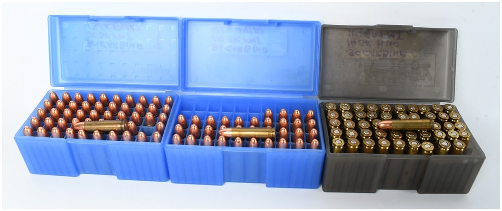 A Lot of 135 Rounds of .30 Carbine Ammunition: This lot consists of 135 live rounds of .30 Carbine ammunition featuring 110-grain full metal jacket projectiles, organized within three plastic storage cases including two blue containers and one gra