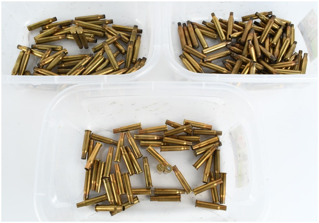 A Collection of 175 .30-06 Springfield, .25-06 Remington, and .30-30 Winchester Brass Casings: This lot consists of a collection of 175 spent brass rifle ammunition casings organized into three clear plastic containers. As per user-provided counts, the assortment includes 55 .30-06 Springfield 