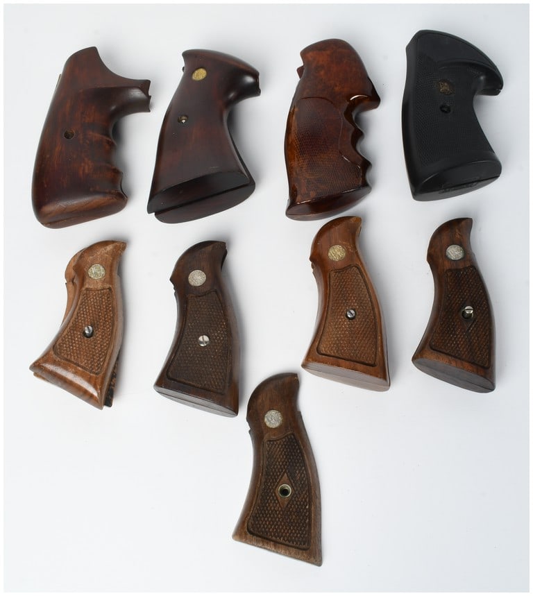 A Collection of Nine Vintage Wood and Synthetic Pistol Grips: A collection of nine vintage pistol grips and panels constructed from wood and synthetic materials. The assortment features several sets of checkered wood target-style grips with finger grooves and tr