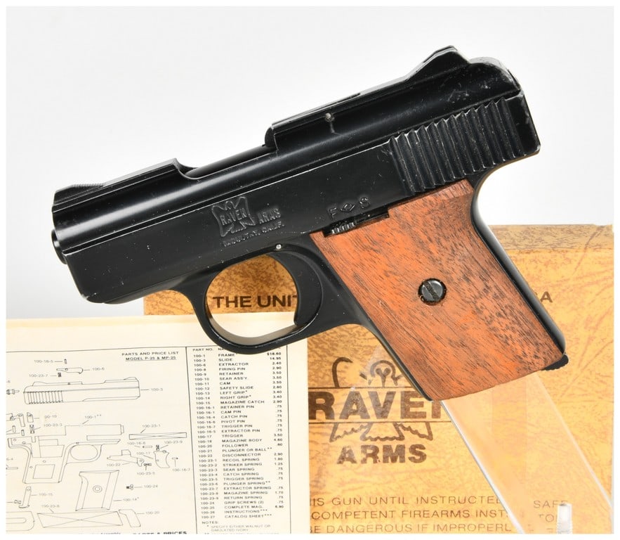 Raven Arms Model MP-25 Semi-Automatic Pistol .25 Auto: This Raven Arms Model MP-25 is a compact semi-automatic pocket pistol chambered in .25 Auto caliber. The firearm features a black blued finish and smooth walnut wood grip panels. The left side of the 