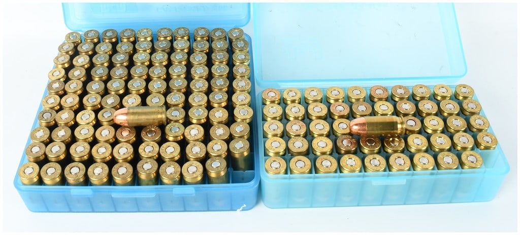 A Lot of 150 Rounds of .45 Auto Ammunition: This lot contains 150 rounds of .45 Auto (.45 ACP) ammunition, organized within two blue translucent plastic flip-top storage cases. The collection features a variety of brass casings from multiple ma