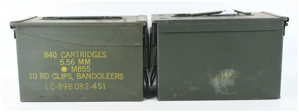 Two US Military M2A1 Steel Ammunition Cans: This lot consists of two US military standard-issue M2A1 ammunition storage containers. Constructed of heavy-duty steel with an olive drab green finish, these cans feature top-mounted folding carry ha