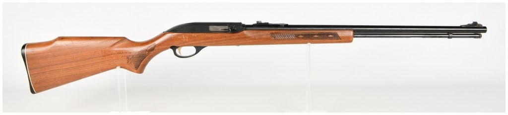 Marlin Model 990 Semi-Automatic Rifle .22 LR: This Marlin Model 990 is a semi-automatic rifle chambered for .22 Long Rifle cartridges, featuring a blued steel barrel and receiver with a full-length tubular magazine. The barrel is roll-marked THE 