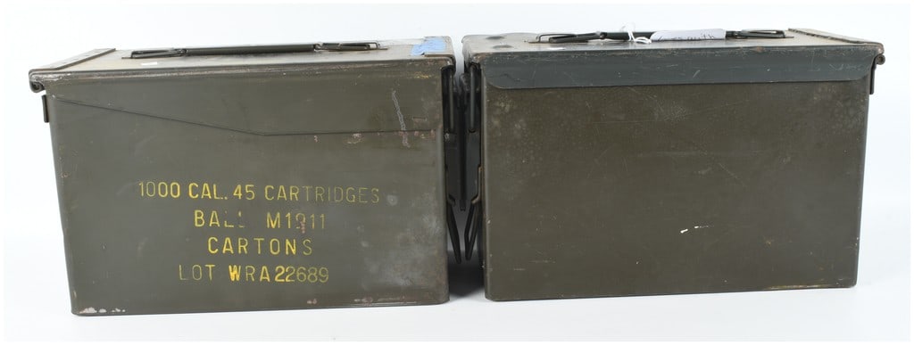 Two US Military Steel Ammunition Cans for .45 Caliber Cartridges: This lot features two vintage US military steel ammunition cans, finished in olive drab green. These containers were designed for the transport and storage of .45 caliber ammunition and feature a top-