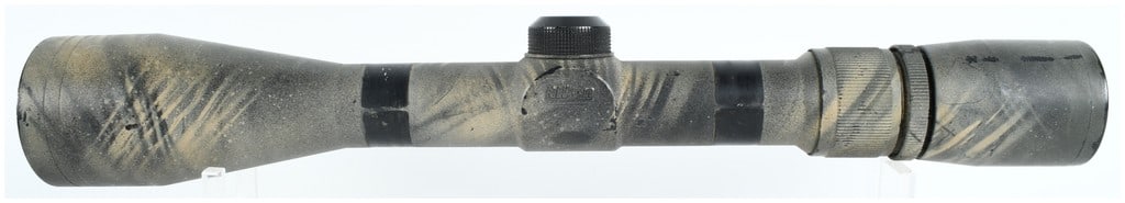 Nikon 3-9x40 Rifle Scope with Custom Camouflage Finish: A Nikon variable-power rifle scope featuring a 3x to 9x magnification range and a 40mm objective lens. The exterior main tube and housing are coated in a custom, weathered camouflage-style paint finis