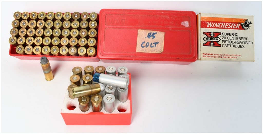 A Lot of 68 Cartridges of Mixed Manufacturer .45 Colt Ammunition: This lot consists of 68 cartridges of .45 Colt ammunition along with associated vintage packaging. The collection is primarily housed in a red MTM Case-Gard plastic ammunition box containing 50 rounds