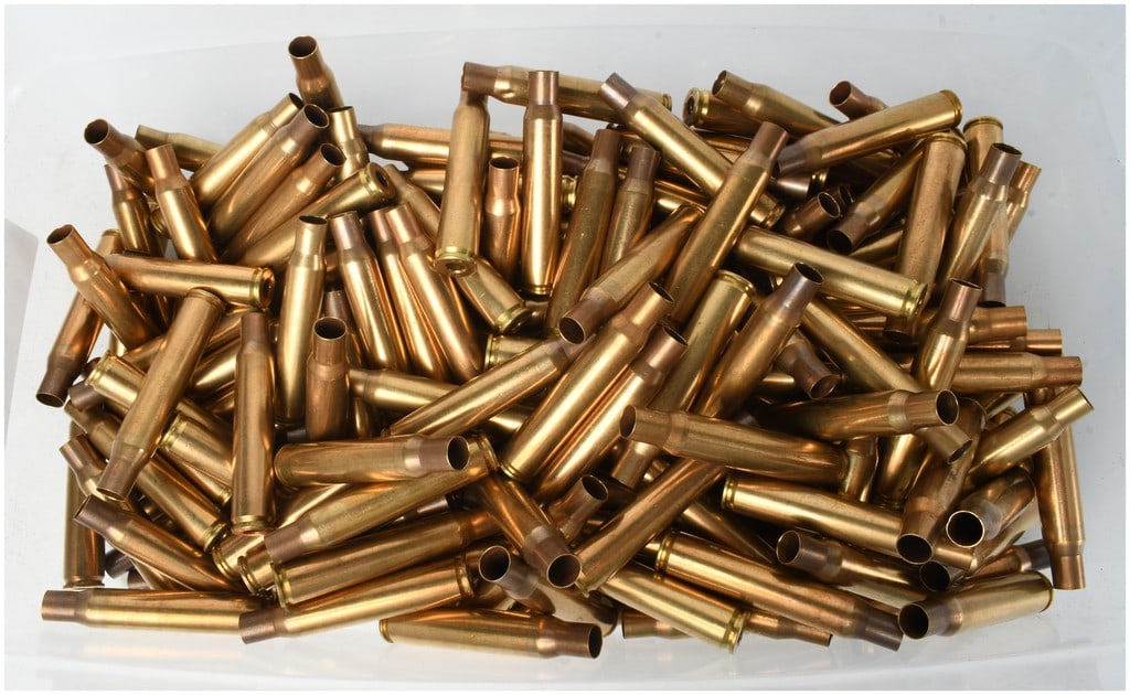 200 Cleaned 30/06 Brass Casings: A collection of 200 cleaned 30/06 brass rifle casings. These bottleneck, rimless casings feature embossed headstamps including the characters TW and 42, which are marks associated with production at t