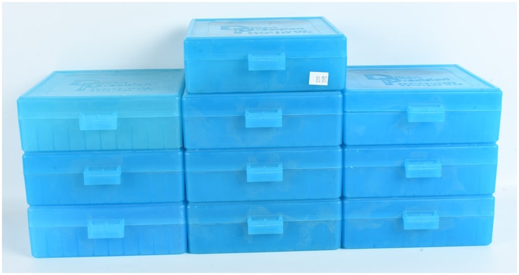 10 Dillon Precision Blue Plastic Ammunition Storage Boxes: This lot consists of 10 ammunition storage boxes manufactured by Dillon Precision. Each box is constructed from translucent blue plastic and features a hinged flip-top lid with a dual-prong front snap
