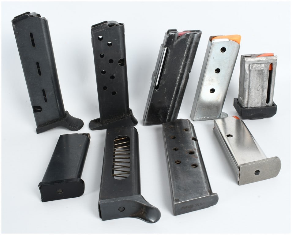A Collection of 9 Assorted Pistol Magazines of Various Calibers: This lot features 9 small caliber mags in a variety of styles and configurations, suitable for several semi-automatic pistol models. The collection includes five magazines in an upright position and f