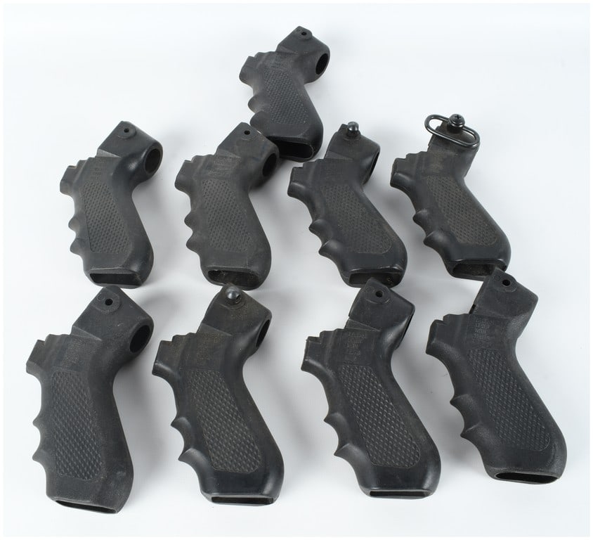 A Lot of Nine Pistol Grips for Folding Stocks: A lot of nine (9) pistol grips attributed to Choate Tool Corp, designed for use with folding stock assemblies. These grips are constructed from black molded polymer and feature checkered side panels w