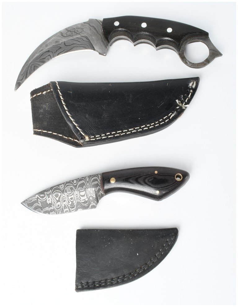 Two Fixed Blade Damascus Steel Knives including a CFK Cutlery Company Karambit and a Custom Camping: This lot consists of two custom fixed-blade knives, each paired with a fitted black leather sheath. The first knife is a custom CFK Cutlery Company Damascus steel karambit. The curved Damascus steel b