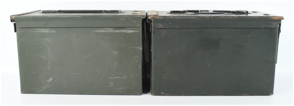 A Pair of US Military M2A1 .50 Caliber Steel Ammunition Cans: This lot consists of two US military M2A1 ammunition cans, which are the standard-issue containers for the storage and transport of .50 caliber small arms ammunition. Each container is constructed of 