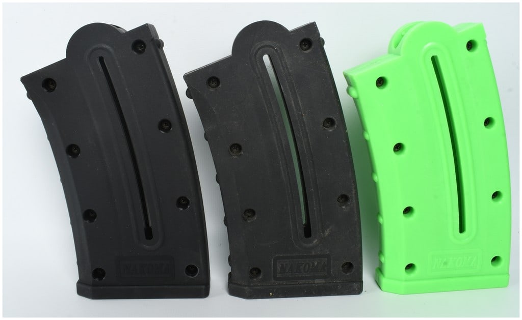 Three Nakoma .22 LR Polymer Magazines: A group of three aftermarket polymer magazines chambered for .22 LR rimfire cartridges, comprising two in black and one in neon green. Each curved magazine is constructed from molded polymer panels se