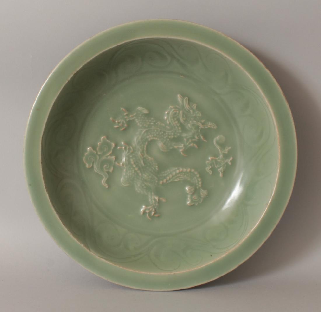 A LARGE MING STYLE LONGQUAN MOULDED CELADON DISH, the (1 of 7)