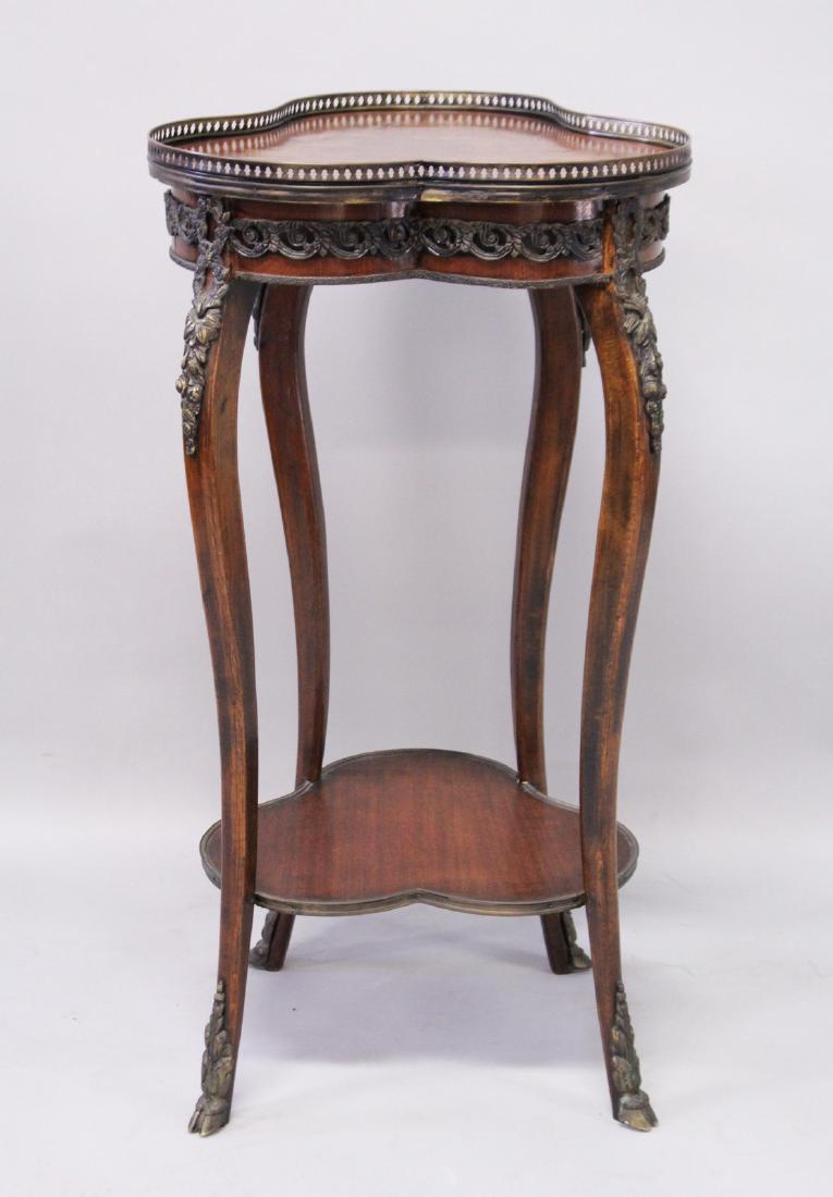 A FRENCH MAHOGANY, MARQUETRY AND ORMOLU TWO TIER: A FRENCH MAHOGANY, MARQUETRY AND ORMOLU TWO TIER OCCASIONAL TABLE, of trefoil shape with galleried top on slender legs. 1ft 6ins wide x 2ft 11ins high.